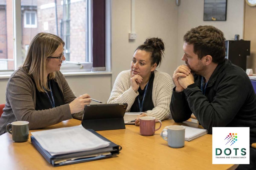 Frontline professionals discussing safeguarding concerns and escalation pathways during a risk review